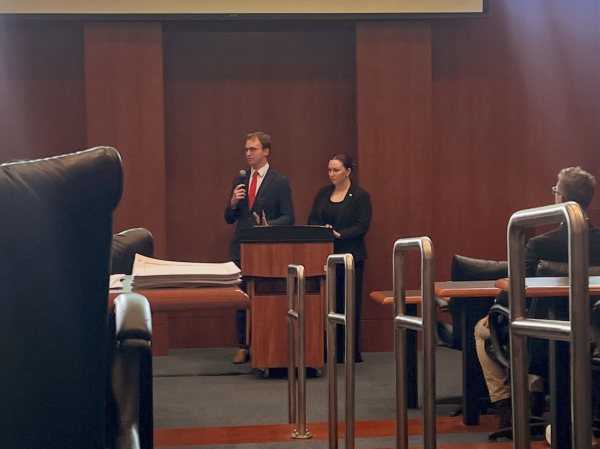 Barcal and Davidson presenting the UNF Student Government Executive Commissions Statute 2025 for BSU and Pride Club during the SG Senate meeting.